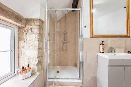 a bathroom with a shower and a sink at 1 Promenade View in Cromford