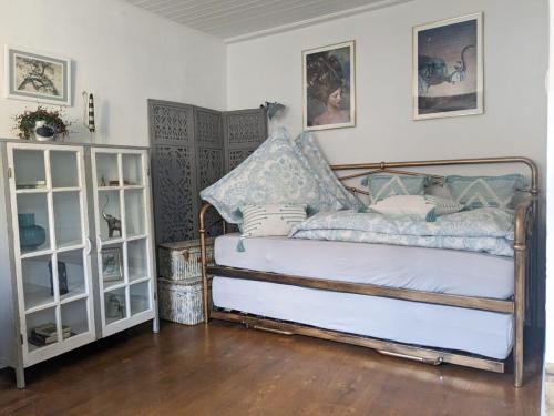 a bedroom with a bed and two white shelves at Kleine Villa - ganzes Stadthäuschen für Gruppen Familien oder nur zu Zweit in Bamberg