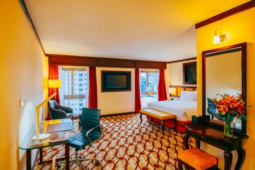 a hotel room with a bed and a mirror at Mövenpick Hotel & Residences Nairobi in Nairobi