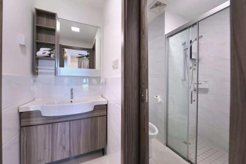 a white bathroom with a sink and a shower at 09 forest city homestay-温馨小筑 in Johor Bahru