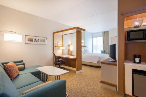 a hotel room with a couch and a bed at SpringHill Suites by Marriott Mount Laurel in Mount Laurel