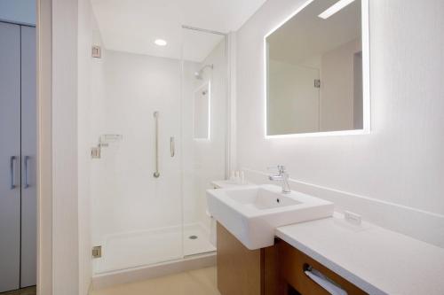 a white bathroom with a sink and a shower at SpringHill Suites by Marriott Mount Laurel in Mount Laurel