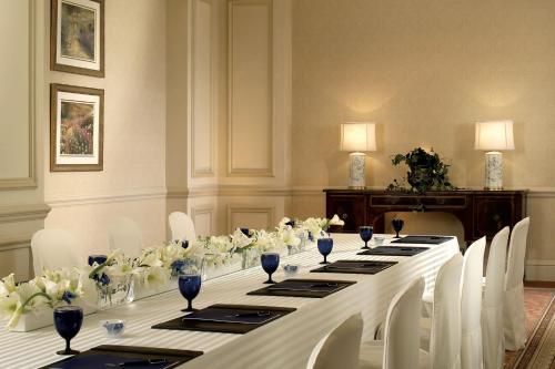 a long table with white flowers in a room at The Ritz-Carlton Osaka in Osaka