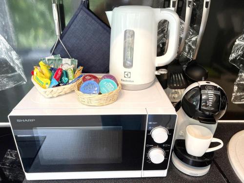 a microwave with eggs in baskets on top of it at New Modern Apartments in the City Center in Narva