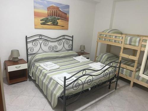 a bedroom with a bed and a bunk bed at Casa Giancontieri in Marinella di Selinunte