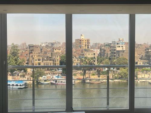 a view of a river from a window at الزمالك ابو الفداء على النيل in Cairo