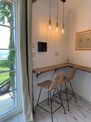 a dining room with a table and chairs and a window at Casale Osvalda in Alfiano Natta