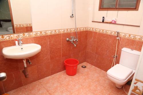 a bathroom with a toilet and a sink at The Nest Lovely 3BHK and 1BHK Villa in Chennai