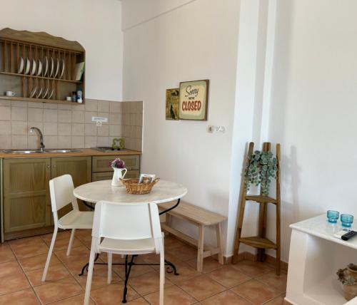 a kitchen with a table and chairs in a room at Alonia Studios in Firostefani