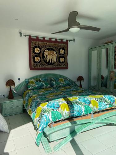 a bedroom with a bed with a colorful comforter at VILLA MARILIS in Montauroux