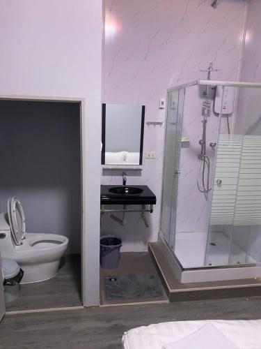 a bathroom with a shower and a toilet and a sink at Mekong Riverside in Vientiane