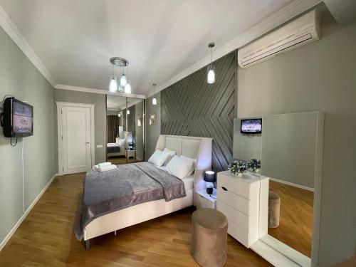 a bedroom with a bed and a television in it at Studio Apartment in Baku