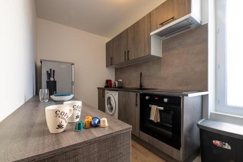 a kitchen with a counter with a stove top oven at Le Charentais #Confort #RDC in Cognac