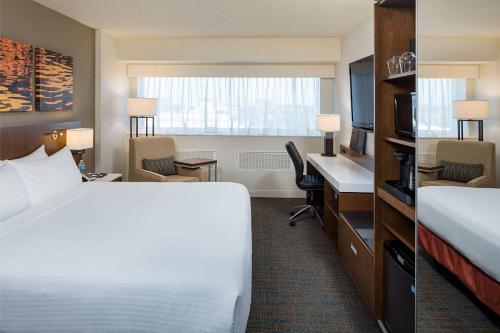 a hotel room with a bed and a desk at Delta Hotels by Marriott Calgary South in Calgary
