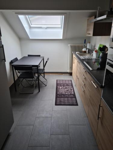 a kitchen with a table and a dining room at appartement 3 pce 