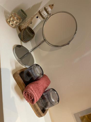 a bathroom with a mirror and a towel at Maison Coxyde in Koksijde