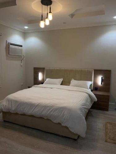 a bedroom with a large bed and a tv at سكنك المريح in Jeddah