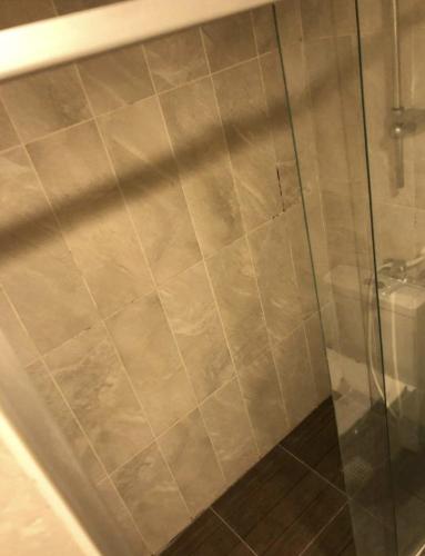 a shower with a glass door next to a toilet at ALASKA TUYAP PALACES in Istanbul