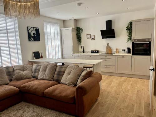 a living room with a couch and a kitchen at Coastal Apartments No 2 in Seaham
