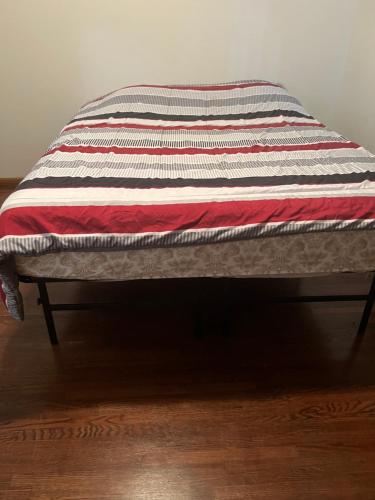 a quilt is sitting on top of a bench at Lake house # 1 in Tacoma