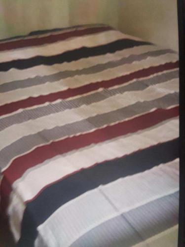 a close up of a bed with red and white stripes at Lake house # 1 in Tacoma