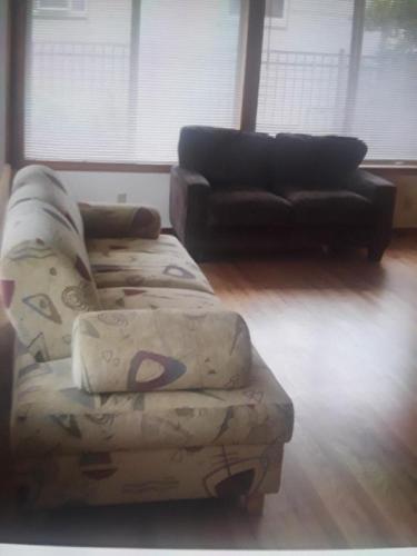 a living room with a couch and a ottoman at Lake house # 1 in Tacoma