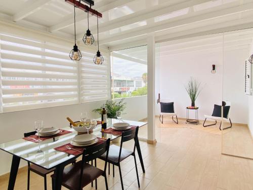 a dining room with a table and chairs and a large window at Casa del Mayor in Playa Honda