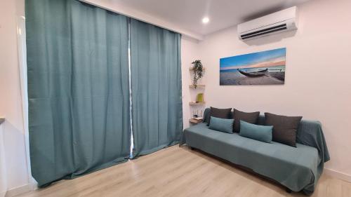 a living room with a couch in front of a window at Mariposa Azul in Adeje