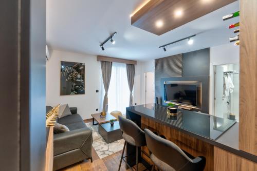 a living room with a couch and a television at Apartman Riva in Vrnjačka Banja
