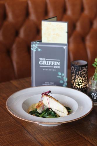 a plate of food on a wooden table with a plate of food at The Griffin Inn in Saint Helens