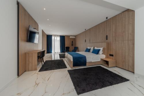 a hotel room with a bed and a desk at Rei Lux in Belgrade