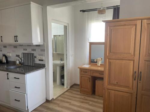 a kitchen with a sink and a counter top at Tugay Hotel in Fethiye