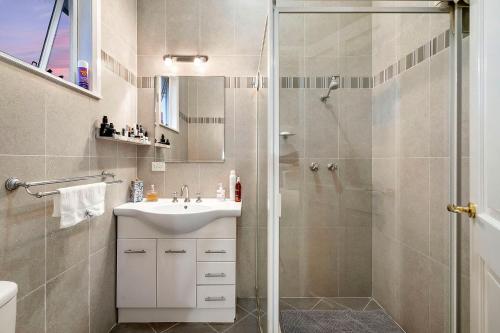 a bathroom with a shower and a sink at Fremantle Accommodation Villas Arundel St in Fremantle