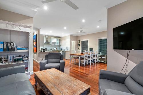 a living room with a couch and a table at Fremantle Accommodation Villas in Fremantle