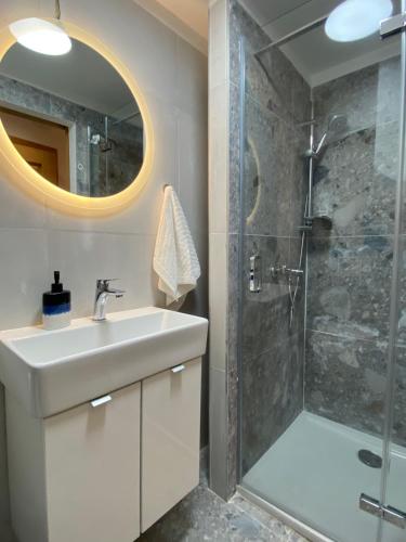 a bathroom with a sink and a shower at House Malena - Rooms in Vis