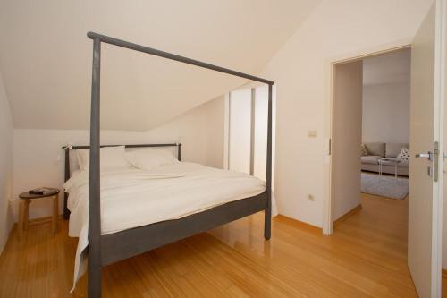 a bedroom with a bed with a metal frame at Apartment St.Jacob in Dubrovnik
