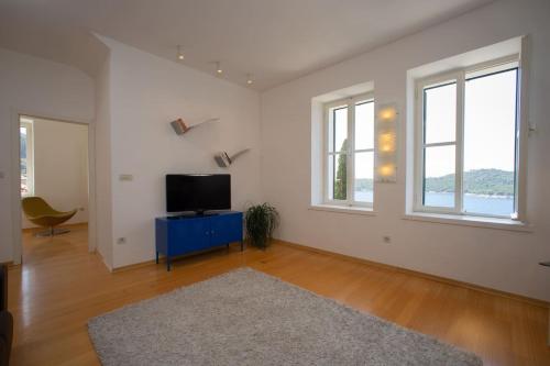 a living room with a tv and a blue cabinet at Apartment St.Jacob in Dubrovnik