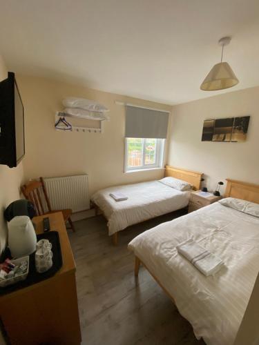 a hotel room with two beds and a television at Shenandoah House in Margate