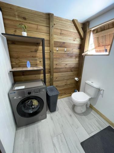 Un baño con lavadora y un inodoro. en Bungalows Lanar'am Kaladja -1, en Bouillante