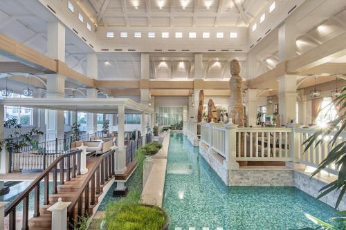 a lobby with a pool in the middle of a building at Titanic Deluxe Golf Belek in Belek