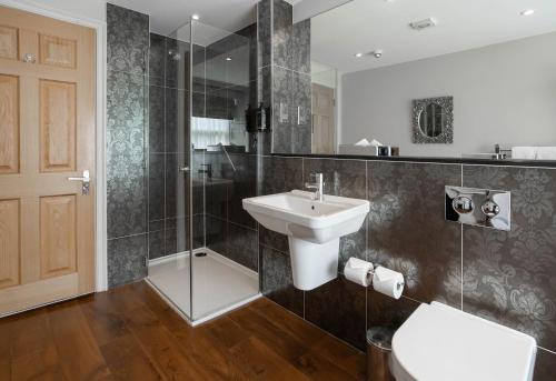 a bathroom with a sink and a shower at Barton Hall Hotel & Spa in Kettering