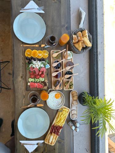 a table filled with plates of food and bread at Angel View Suites in Goreme