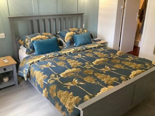 a bedroom with a bed with a blue and gold bedspread at No. 5 Plaisance in Plaisance