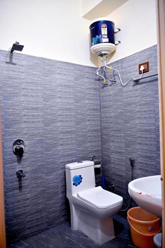 a bathroom with a toilet and a sink at Kareri River Bliss in Dharamshala