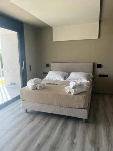 a bedroom with a bed with towels on it at Grand Kourouta in Kourouta