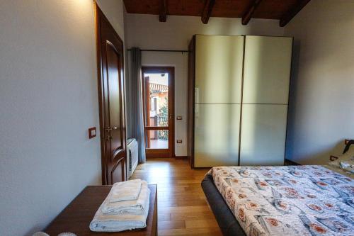 a bedroom with a bed and a large refrigerator at Casa Lilla 1 e 2 in Oristano