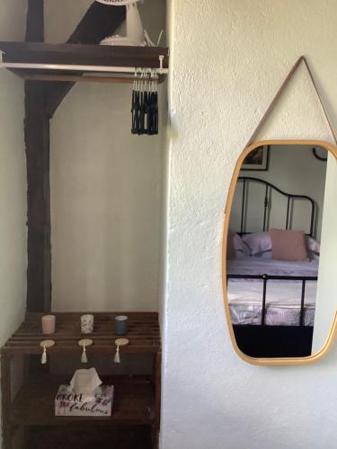 a mirror on the wall of a room with a bed at No. 5 Plaisance - Room 2 in Plaisance
