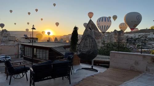 a group of hot air balloons flying in the sky at Angel View Suites in Goreme