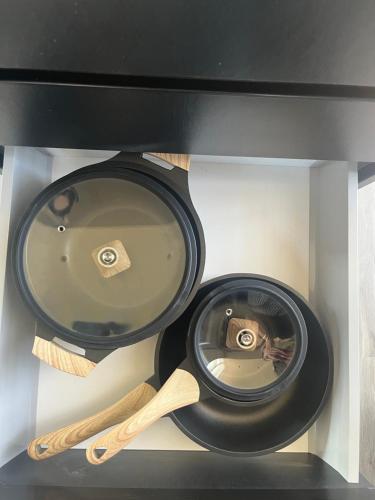 two bowls and wooden utensils in a drawer at Grand Kourouta in Kourouta