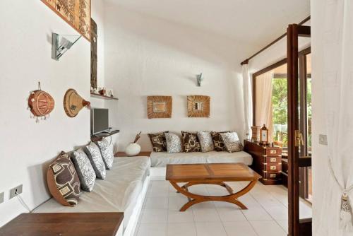 a living room with a couch and a table at Villa Dina with Pool - Costa Paradiso in Costa Paradiso